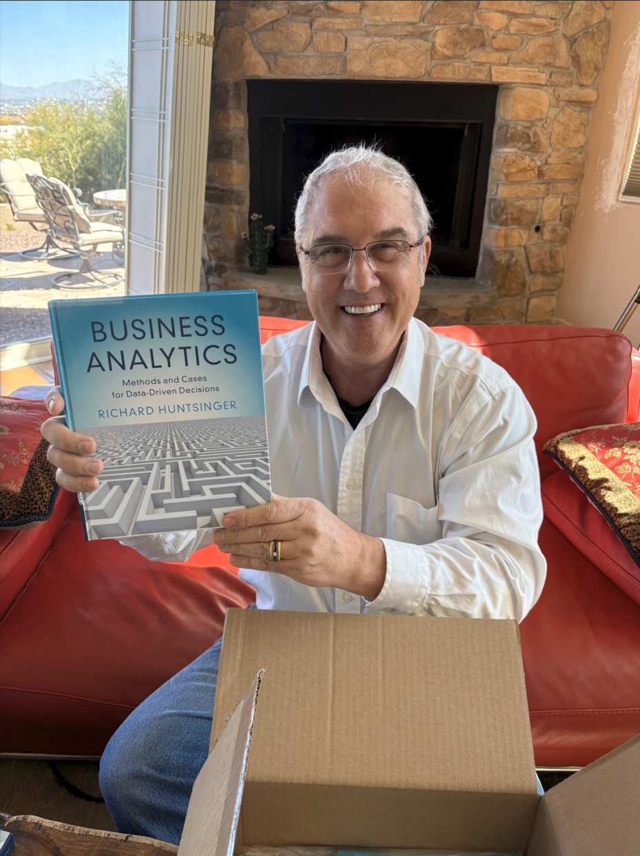 Richard Huntsinger, author of Business Analytics, poses with a print copy of his book
