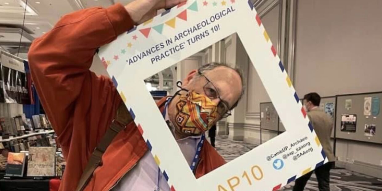 Mitch Allen with a selfie frame, marking 10 years of 'Advances'.
