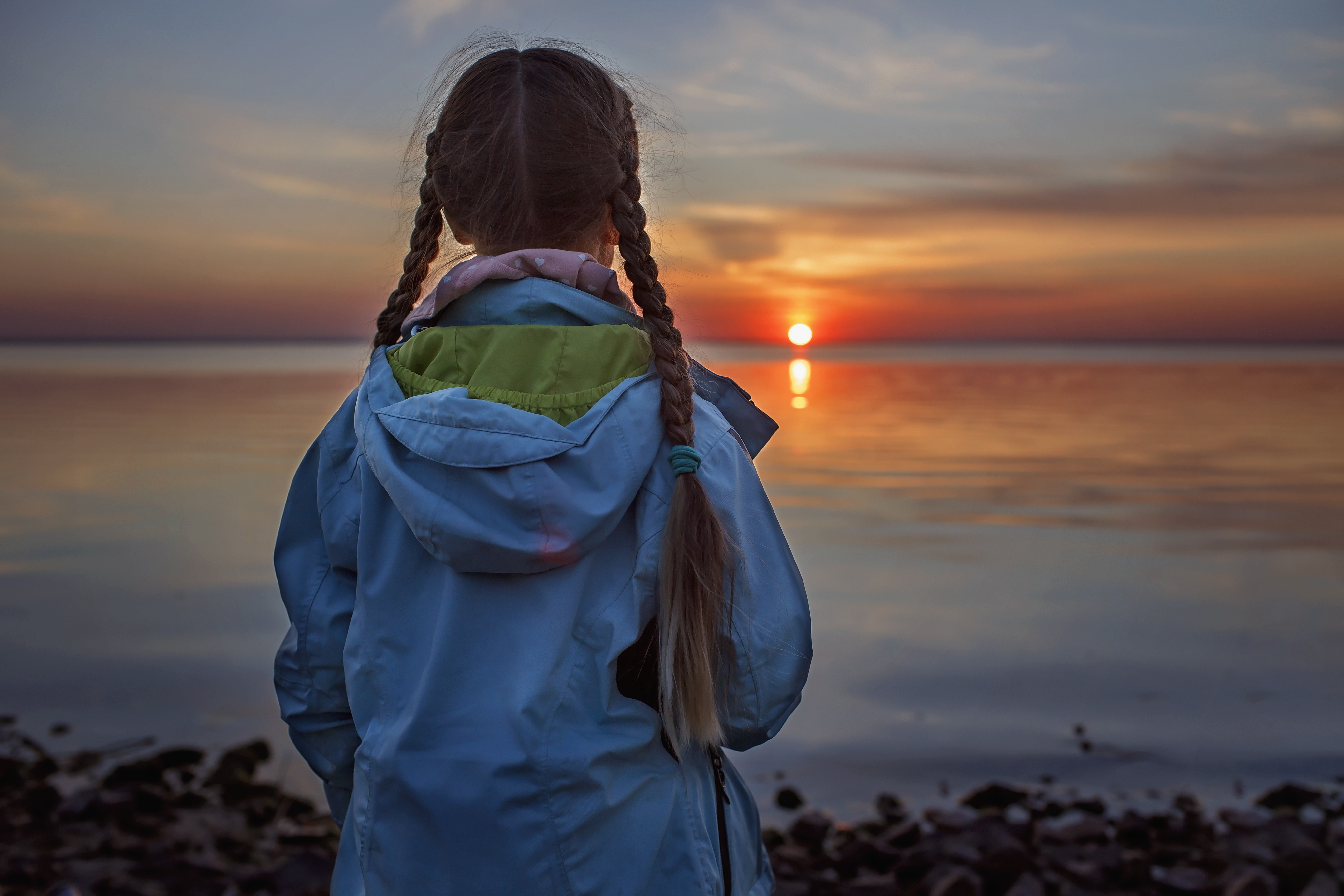 Girl looks into sunset