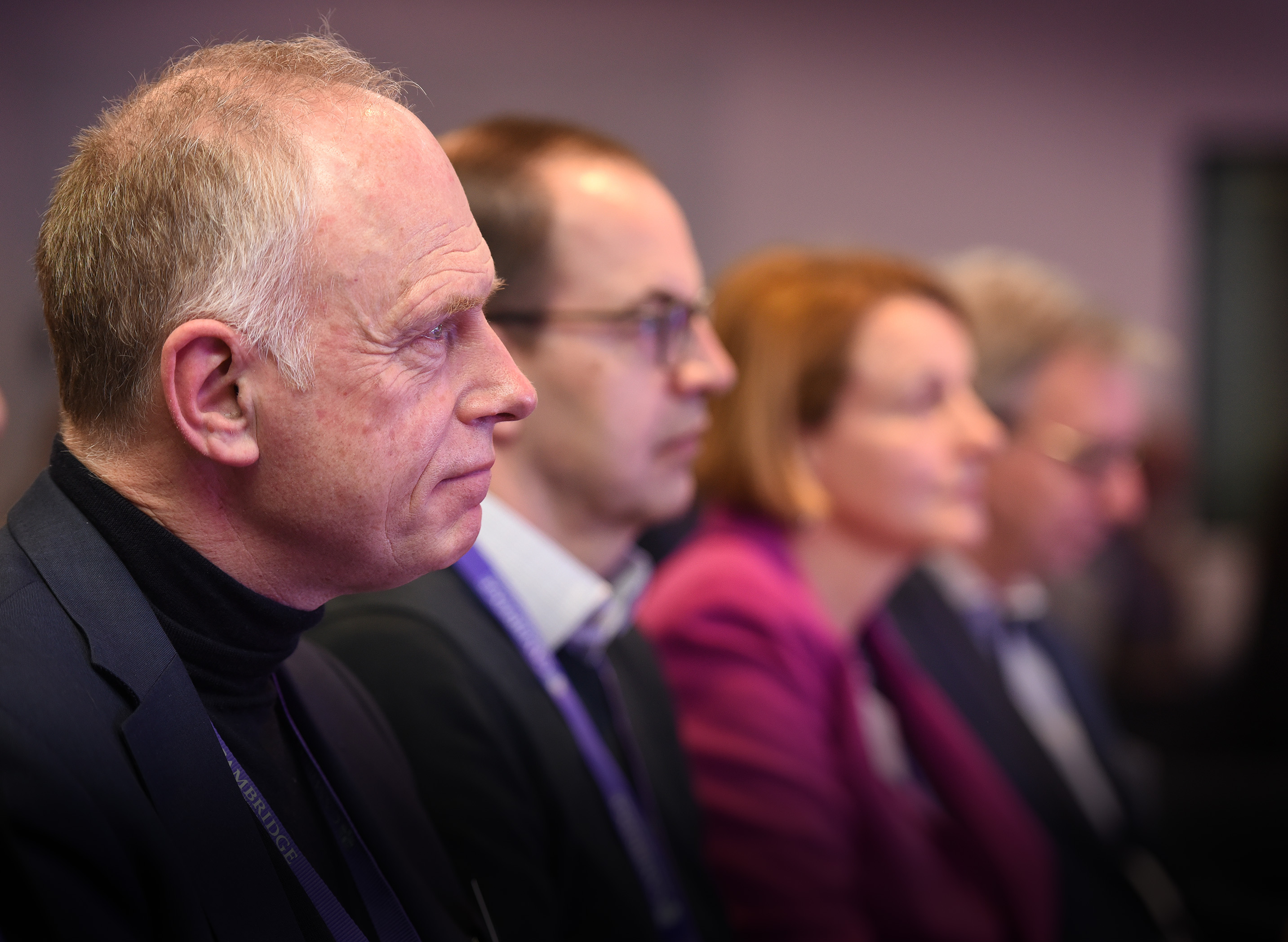 Peter Phillips sits in the audience at Digital & Data Day looking towards the main stage watching and listening next to colleagues