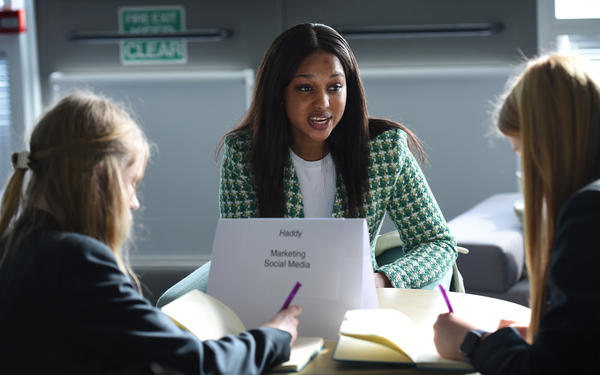 Haddy Ndure speaking to students at a careers event 