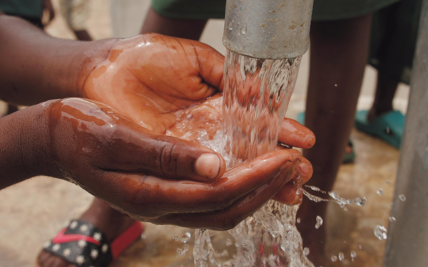 Close-up Of A Child's Hands holding water