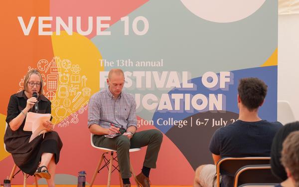 Panel members speaking on stage at Festival of Education