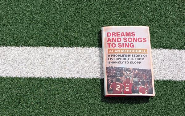 Dreams and Songs to Sing book on a football pitch