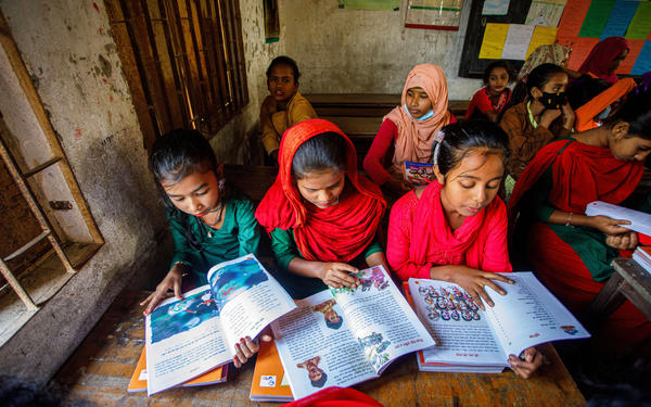 Kids read textbooks in classroom