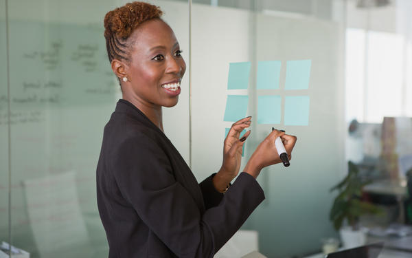 Woman writes on post-it notes