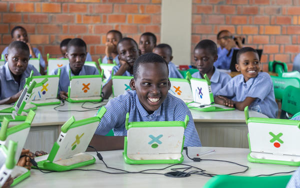 Children using laptops in class in Rwanda