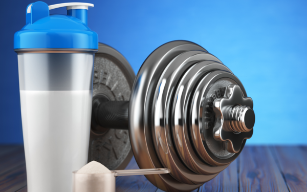 Image of supplement next to a dumbbell