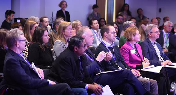 People sitting in chairs as audience members at Digital & Data Day listening to a person speaking on stage out of frame
