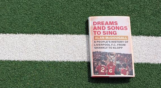 Dreams and Songs to Sing book on a football pitch
