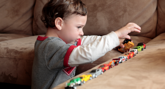 Autistic boy lines up cars to create order in his world